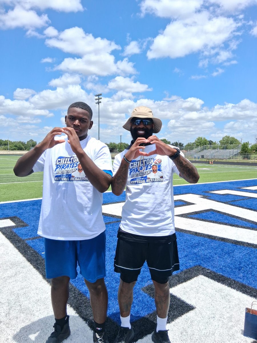 Matterial Richardson and player making heart hands at camp
